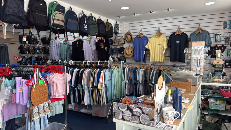 Selection of surf backpacks, surf wax, surfing T-shirts and sandals