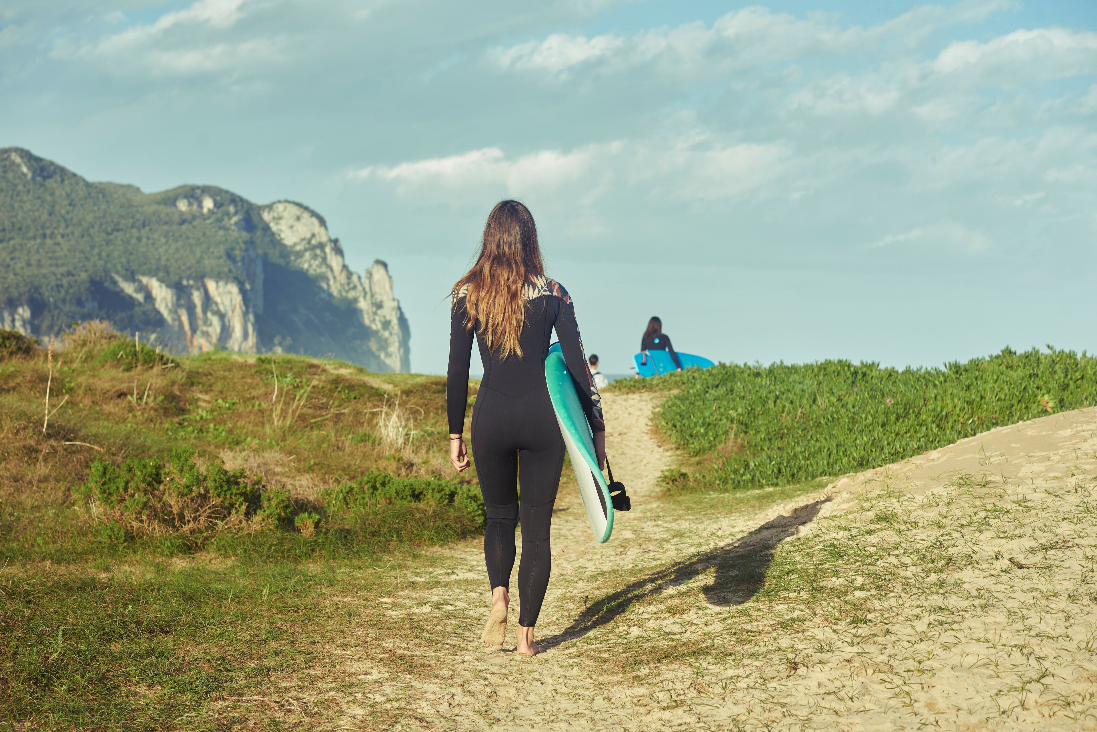 Girl going surfing in Gower
